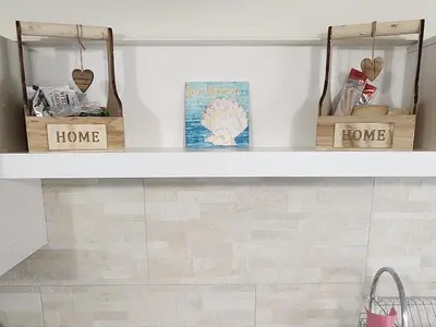 a shelf in a bathroom with two baskets on it at Don Vito's Home, DsG2 Short Lets, 250 mt Metrò in Palermo