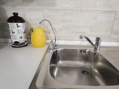 a kitchen counter with a sink and a yellow vase at Don Vito's Home, DsG2 Short Lets, 250 mt Metrò in Palermo