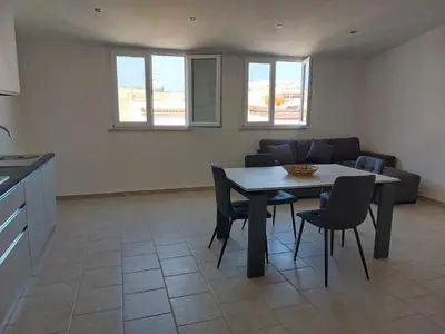 a living room with a table and chairs and a couch at Levante in Terrasini