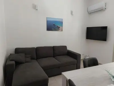 a living room with a couch and a flat screen tv at Levante in Terrasini