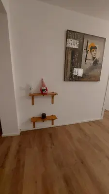 a white room with a table and a picture on a wall at A CASA DI ELENA in Palermo