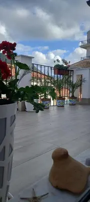a vase of flowers sitting on top of a balcony at Regina Stella in Lascari