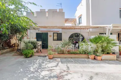 a house with a courtyard with plants in front of it at Isulidda Gaia Mare in San Vito lo Capo