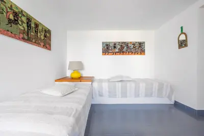 a bedroom with two beds and a lamp on a table at Isulidda Gaia Mare in San Vito lo Capo