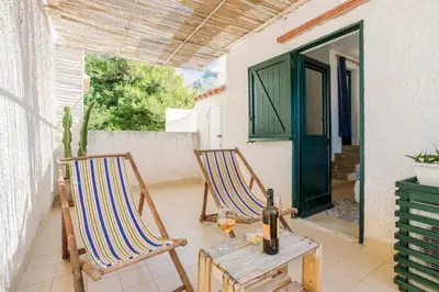 two chairs and a table on a patio at Isulidda Gaia Mare in San Vito lo Capo