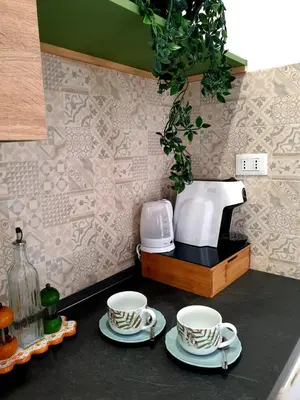 a kitchen counter with two cups and a coffee maker at Le Due Perle in Palermo