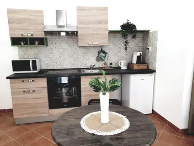 a kitchen with a table with a potted plant on it at Le Due Perle in Palermo