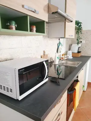 a kitchen with a microwave on top of a counter at Le Due Perle in Palermo