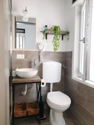 a bathroom with a white toilet and a sink at Le Due Perle in Palermo