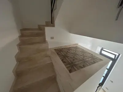 a staircase in a house with a wooden stair case at La Nicaredda in Alcamo