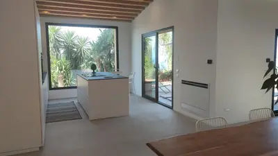 a kitchen with a table and a large window at Casa di Pino in Cefalù