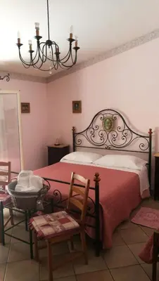 a bedroom with a large bed with a red blanket at Cinisi 89 B&B in Cinisi