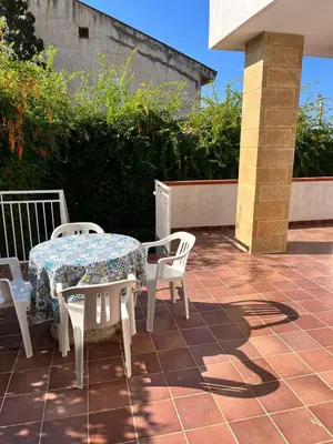 a table and chairs sitting on a patio at Villa Capri Holiday Home in Campofelice di Roccella