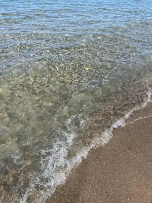 a close up of the water on the beach at Villa Capri Holiday Home in Campofelice di Roccella