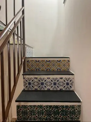 a stairway with tiles on the stairs at Casetta di Ale al Capo in Palermo