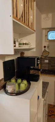 a kitchen with a bowl of apples on a counter at Casetta di Ale al Capo in Palermo