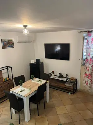 a living room with a table and a television at Casetta di Ale al Capo in Palermo