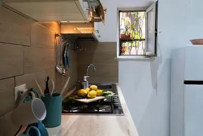 a kitchen with a stove with a plate of fruit on it at Santa Cecilia House centro Palermo-350 mt stazione in Palermo