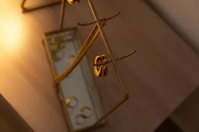 a mirror on a wall next to a clock at Santa Cecilia House centro Palermo-350 mt stazione in Palermo