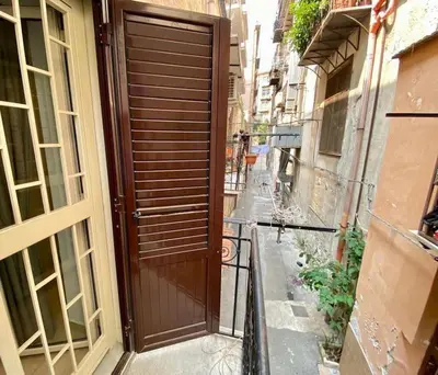 a brown door on a building with a street at Santa Cecilia House centro Palermo-350 mt stazione in Palermo
