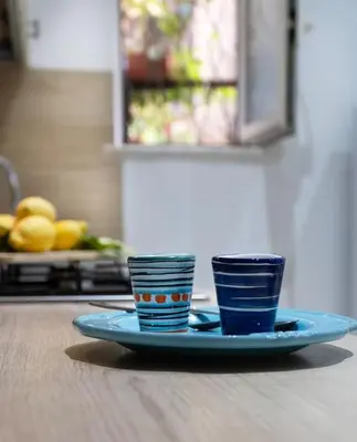 two cups on a plate on a table at Santa Cecilia House centro Palermo-350 mt stazione in Palermo
