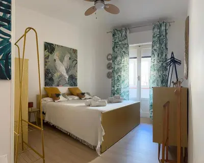 a bedroom with a bed and a ceiling fan at casa vacanze Mondello mare piscina CHIFEVI in Mondello