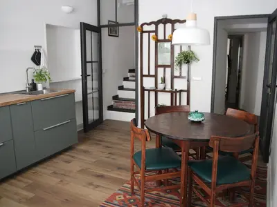 a kitchen and dining room with a table and chairs at Il corvo e la volpe in Palermo