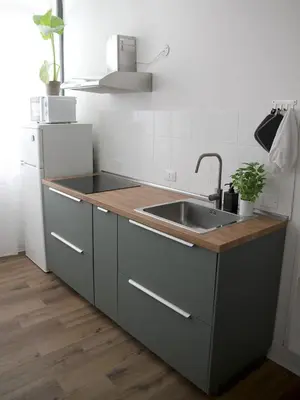 a kitchen with a sink and a refrigerator at Il corvo e la volpe in Palermo