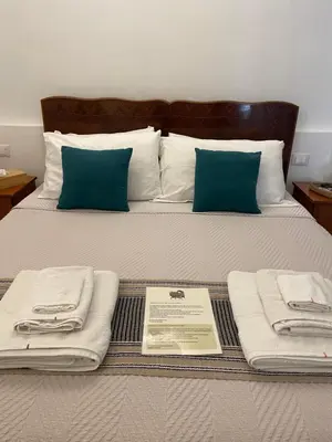 a bed with towels and pillows on it at Il corvo e la volpe in Palermo