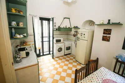 a small kitchen with a refrigerator and a stove at Il Gelsomino in Palermo