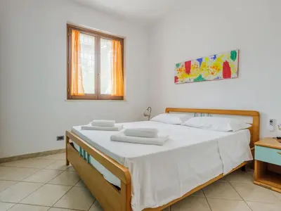 a bedroom with a bed with white sheets and a window at Holiday Home Acquamarina Gaia by Interhome in San Vito lo Capo