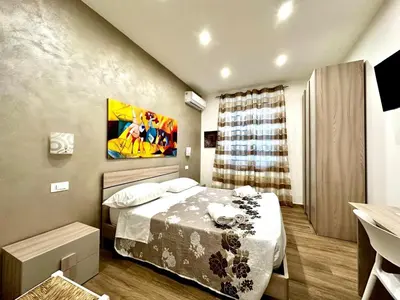 a small bedroom with a bed and a window at MD APARTAMENT CORAL BAHLARA in Palermo