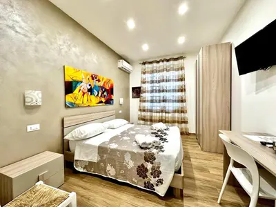a small bedroom with a bed and a desk at MD APARTAMENT CORAL BAHLARA in Palermo