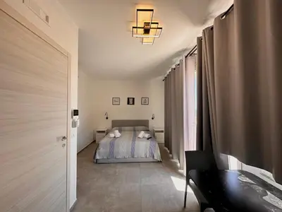 a bedroom with a bed and a desk in a room at Summer Vibes in Castellammare del Golfo