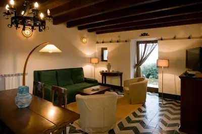 a living room with a green couch and a table at Casa Margaret in Collesano