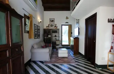 a living room with a couch and a table at Casa Margaret in Collesano