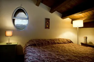 a bedroom with a bed and a round window at Casa Margaret in Collesano