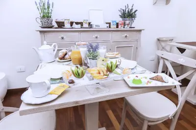 a breakfast table with food and drinks on it at Stupor Mundi Bed and Breakfast in Palermo