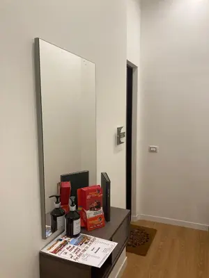 a large mirror on a wall next to a table at Nigra Apartments in Palermo