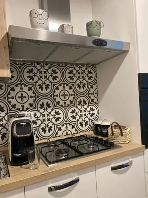 a kitchen with a stove and a black and white wallpaper at Nigra Apartments in Palermo