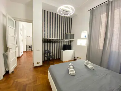 a bedroom with a bed with shoes on it at Kamaffari Central Apartment in Palermo