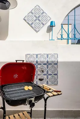 a grill with two coins on it next to a wall at Madre Terra Airport Apartment & Rooms in Terrasini