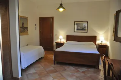 a hotel room with two beds and a table at Punto de Vista B&B Makari in San Vito lo Capo