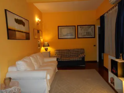 a living room with a white couch and yellow walls at Alle Terrazze del Borgo Vecchio in Palermo
