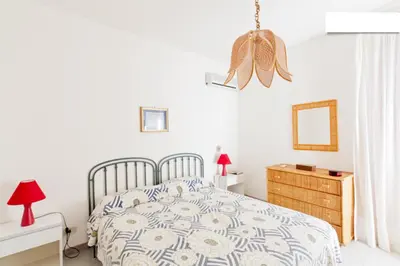 a bedroom with a bed and a dresser and a mirror at Villa Verdemare in San Vito lo Capo