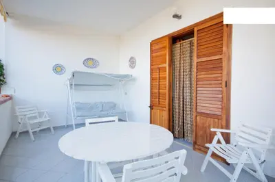 a white table and chairs in a room at Villa Verdemare in San Vito lo Capo