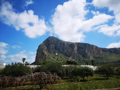 a mountain in the distance with a blue sky and clouds at Villa Verdemare in San Vito lo Capo