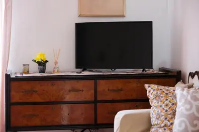 a white couch in a living room with a painting on the wall at Appartamento nel centro storico di Palermo - Via Meli's House in Palermo