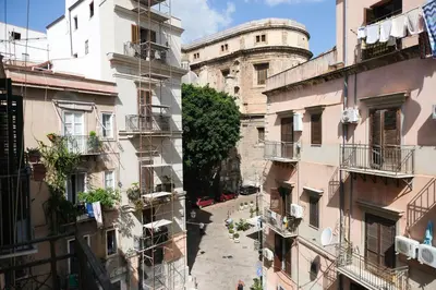 a balcony with a table and potted plants on it at Appartamento nel centro storico di Palermo - Via Meli's House in Palermo