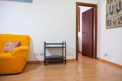 a living room with a yellow couch and a wooden floor at Appartamento nel centro storico di Palermo - Via Meli's House in Palermo